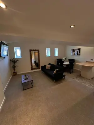 a living room with a couch and a table at City Centre Duplex Apartment Liverpool in Liverpool