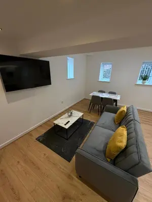 a living room with a couch and a flat screen tv at City Centre Duplex Apartment Liverpool in Liverpool