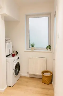 a laundry room with a washing machine and a window at Platt Bridge Contractor Stays-2 bedroom house in Abram