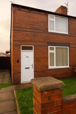 a brick house with a white door and windows at Platt Bridge Contractor Stays-2 bedroom house in Abram