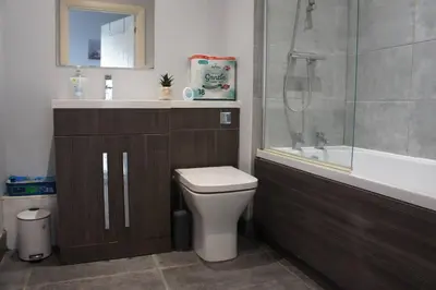 a bathroom with a toilet and a sink and a shower at Melbourne House Gem Stylish 2-Bed in City Centre in Accrington