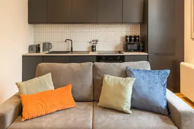 a couch with three pillows on it in a kitchen at Modern 3 beds APT, 2 Baths, Free Parking in Liverpool