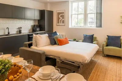 a living room with a couch and a table at Modern 3 beds APT, 2 Baths, Free Parking in Liverpool