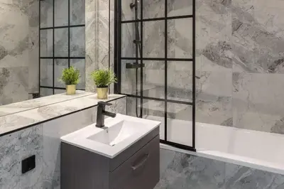 a bathroom with a sink and a bath tub at Modern 3 beds APT, 2 Baths, Free Parking in Liverpool