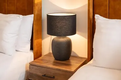 a lamp sitting on a night stand next to two beds at Modern 3 beds APT, 2 Baths, Free Parking in Liverpool