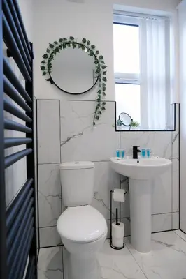 a white bathroom with a toilet and a sink at Antrim House by Serviced Living Liverpool in Liverpool