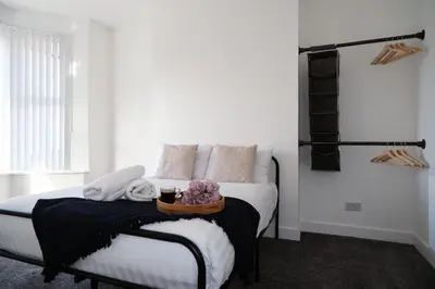 a bedroom with a bed with a tray on it at Antrim House by Serviced Living Liverpool in Liverpool