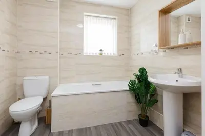a white bathroom with a toilet and a sink at Oxheys Stays - Sleeps 7 - Home from Home in Preston