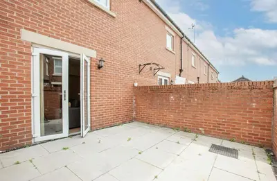 a brick building with a door and a brick wall at Oxheys Stays - Sleeps 7 - Home from Home in Preston
