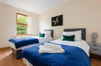 a bedroom with two beds with blue and white sheets at Albert Stays - 5 bed Sleeps 11 - Free Parking in Preston