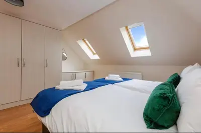 a bedroom with a large white bed with skylights at Albert Stays - 5 bed Sleeps 11 - Free Parking in Preston