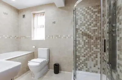 a bathroom with a toilet and a shower and a sink at Albert Stays - 5 bed Sleeps 11 - Free Parking in Preston