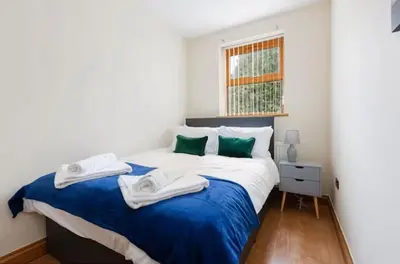 a bedroom with a bed with towels on it at Albert Stays - 5 bed Sleeps 11 - Free Parking in Preston