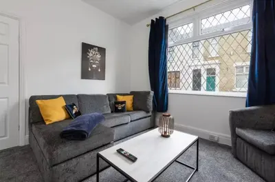 a living room with a couch and a table at Connaught Stays - Home from Home - Sleeps 7 - Free Wifi in Preston