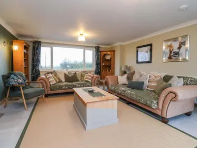 a living room with couches and a coffee table at Brook House in Preston