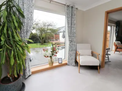 a living room with a chair and a window at Brook House in Preston
