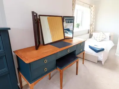 a blue dresser with a mirror on top of it at Brook House in Preston