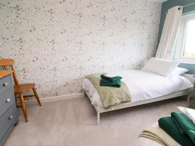 a small bedroom with a bed and a window at Brook House in Preston