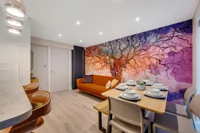 a living room with a table and a couch at 3BR Georgian Quarter Coach Houses - Private Parking in Liverpool