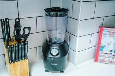 a blender sitting on a counter next to a book at Long Stays Offers , New 2 Bed APT , Sleeps 3 , Wigan , Perfect for Relocations , Contractors , Families in Ince-in-Makerfield