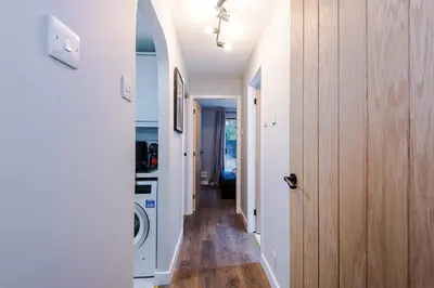 a hallway with a washer and dryer in a house at Long Stays Offers , New 2 Bed APT , Sleeps 3 , Wigan , Perfect for Relocations , Contractors , Families in Ince-in-Makerfield