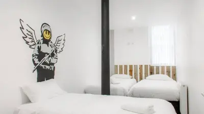 a bedroom with two beds and a mirror at The Bloc - Liverpool Nightlife Apartments in Liverpool