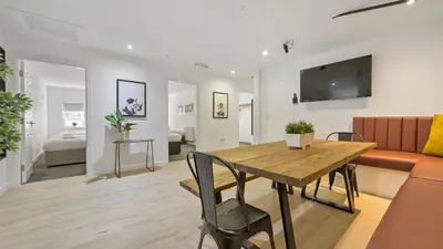 a living room with a table and a couch at The Bloc - Liverpool Nightlife Apartments in Liverpool