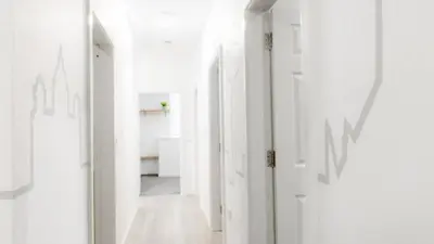 a hallway with white walls and white floors and ceilings at The Bloc - Liverpool Nightlife Apartments in Liverpool