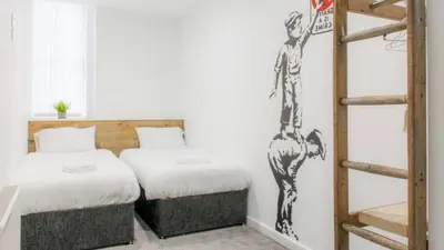 a bedroom with two beds and a ladder at The Bloc - Liverpool Nightlife Apartments in Liverpool