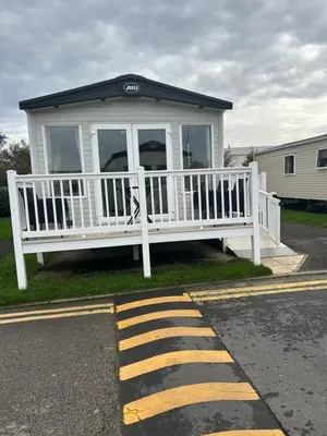 a white house with a porch on the side of the road at Haven Cala gran in 2026 through to Jan 2027 spring summer winter breaks Blackpool Fleetwood entire home 6 people seaside holiday park in Fleetwood