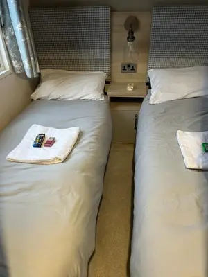 two beds sitting next to each other in a room at Haven Cala gran in 2026 through to Jan 2027 spring summer winter breaks Blackpool Fleetwood entire home 6 people seaside holiday park in Fleetwood