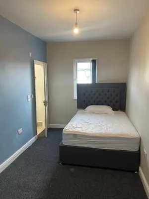 a bedroom with a large bed in a room at Westfield Street in Saint Helens