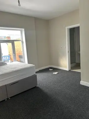 an empty room with a bed and a window at Westfield Street in Saint Helens