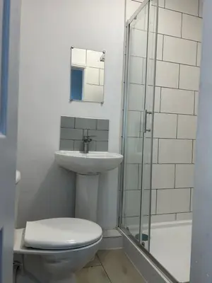 a bathroom with a toilet and a sink and a shower at Westfield Street in Saint Helens