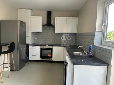 a kitchen with white cabinets and a sink at Westfield Street in Saint Helens
