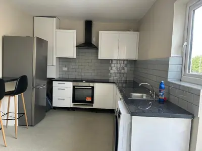a kitchen with a sink and a refrigerator at Westfield Street in Saint Helens