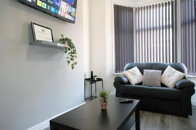 a living room with a couch and a coffee table at Whitland House by Serviced Living Liverpool in Liverpool