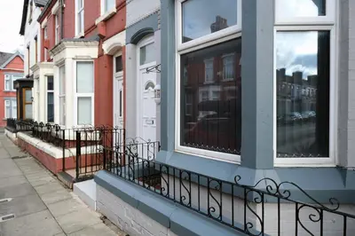 a building with windows on a city street at Whitland House by Serviced Living Liverpool in Liverpool