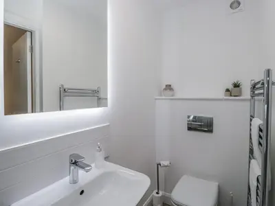 a white bathroom with a sink and a toilet at Ullswater in Ulverston