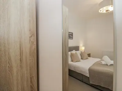 a bedroom with a bed and a mirror in a room at Ullswater in Ulverston