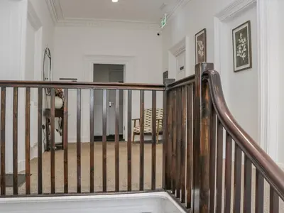 a spiral staircase in a home with white walls at Ullswater in Ulverston