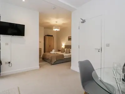 a bedroom with a bed and a glass table at Derwent in Ulverston