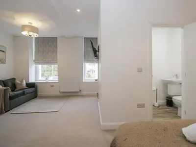 a living room with a bed and a couch at Derwent in Ulverston