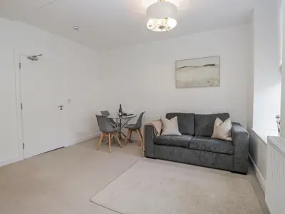 a living room with a couch and a table at Derwent in Ulverston