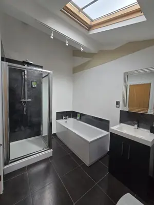 a bathroom with a tub and two sinks and a shower at City Centre Luxury Apartment in Liverpool