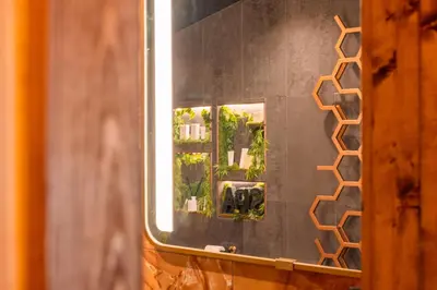 a mirror on a wall in a bathroom at Spa Cottage - Hot Tub, Cold Pod & Sauna in Morecambe