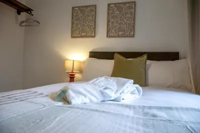 a white towel laying on top of a bed at Modern 3-Bedroom Home - Contractor Friendly - Sleeps 5 - FAST WiFi - Parking in Seacombe