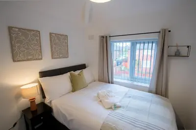 a bedroom with a white bed with a window at Modern 3-Bedroom Home - Contractor Friendly - Sleeps 5 - FAST WiFi - Parking in Seacombe