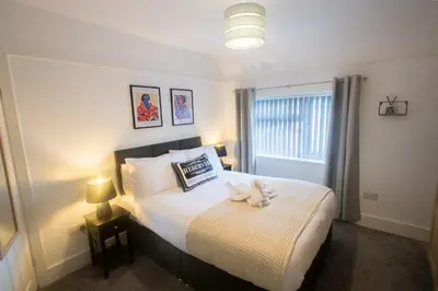 a bedroom with a bed with a stuffed animal on it at Modern 3-Bedroom Home - Contractor Friendly - Sleeps 5 - FAST WiFi - Parking in Seacombe