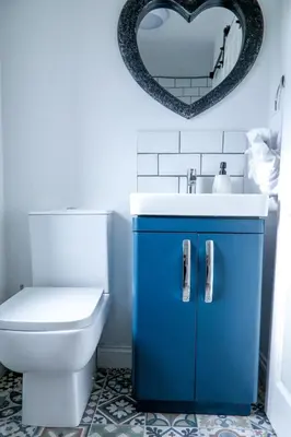a bathroom with a sink and a toilet and a mirror at Modern 3-Bedroom Home - Contractor Friendly - Sleeps 5 - FAST WiFi - Parking in Seacombe